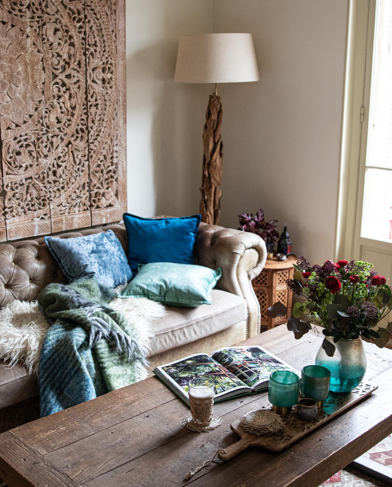 livingroom update mit Samtkissen, Blumen und Windlichtern